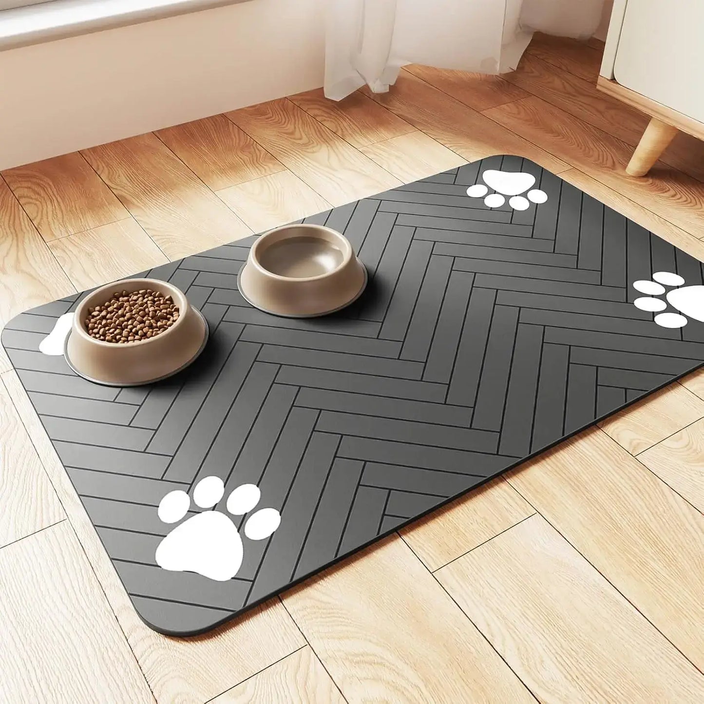 Absorbent pet feeding mat with paw prints, gray design, protecting floors from spills beneath food and water bowls.